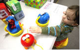 Photo of a toddler playing with toys
