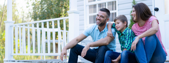 a family sitting oon a porch