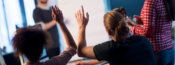 a group of people raisig their hands