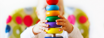 a chile playing with ring blocks