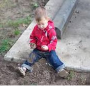 Picture of a kid playing with soil.